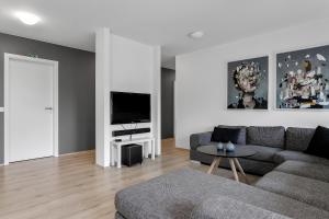 a living room with a couch and a tv at Villa - South Iceland in Laugaras