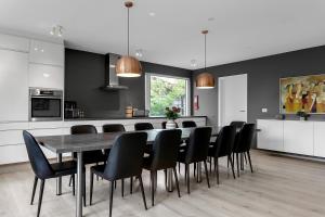a kitchen and dining room with a table and chairs at Villa - South Iceland in Laugaras