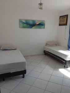 a hospital room with two beds and a window at Apartamento em Ilhéus Pé na Areia in Ilhéus