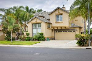 a house with a garage and palm trees at Family-Friendly Manteca Vacation Rental with Pool! in Manteca