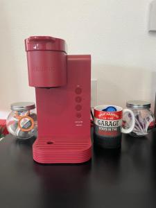 a red blender sitting on a counter next to a can of coffee at The Shop@680 in Columbia Falls