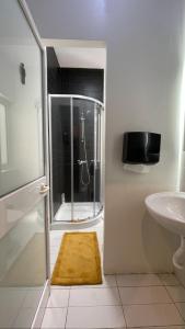 a bathroom with a shower and a sink at Bookarest Hostel Malta in St. Julianʼs