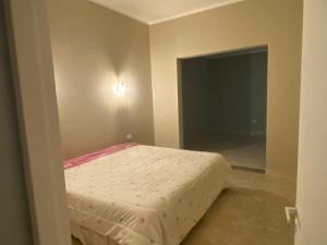 a bedroom with a bed in the corner of a room at La Casa de Nino in Salta