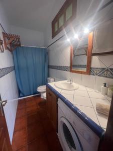 a bathroom with a washing machine and a sink at - Casa Abades dos dormitorios - in Abades