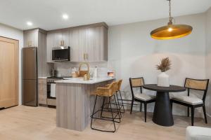 a kitchen with a island in the middle of a room at Resort-Style Brian Head Condo Near Slopes! in Brian Head