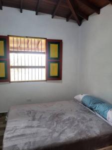 a room with a large bed in a room with two windows at Casa de Campo el mirador in Jericó