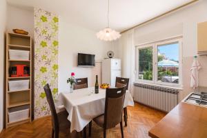 a kitchen and dining room with a table and a window at Apartments in Crikvenica 41682 in Crikvenica