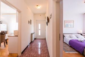 a bedroom with a bed and a hallway with a table at Apartments in Crikvenica 41682 in Crikvenica