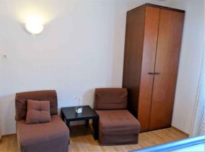 a room with two chairs and a table and a cabinet at Apartments in Crikvenica 41681 in Crikvenica
