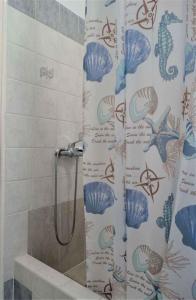 a shower curtain with fish on it in a bathroom at Apartments in Crikvenica 41681 in Crikvenica