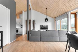 a living room with a couch and a table at Scandinavian villa in South Iceland in Laugaras