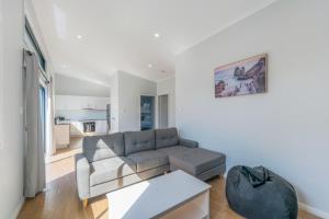 a living room with a couch and a table at Coastal Charm in Port Macquarie