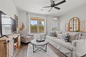 a living room with a couch and a tv at *Brand New Listing* Romantic Getaway Near Main in Fredericksburg