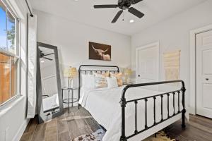 a bedroom with a bed and a ceiling fan at *Brand New Listing* Romantic Getaway Near Main in Fredericksburg