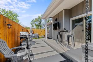 a patio with chairs and a table and a fence at *Brand New Listing* Romantic Getaway Near Main in Fredericksburg