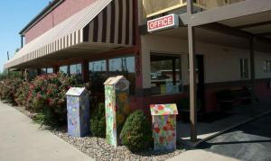 a fast food restaurant with four bins in front of it at Big Bend Traveler's Inn in Great Bend +3 photos
