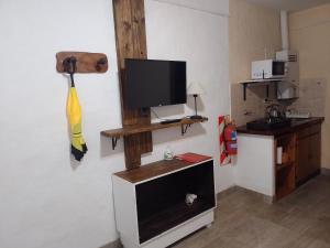 a living room with a television on a wall at Altos de Unzué in Gualeguaychú