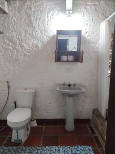 a bathroom with a toilet and a sink and a mirror at Estadía SaraIsa in Cali