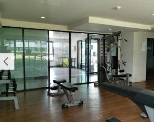 a room with a gym with a treadmill and a simulator at Apartment near Central phuket in Phuket