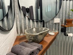 a bathroom with a large stone sink and a mirror at Motel3858 in Heyfield +17 photos