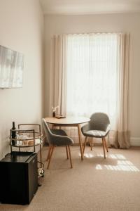 a living room with a table and two chairs at The Oak & Anchor Hotel in Port Fairy