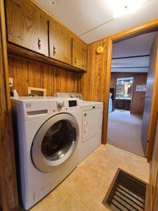 a washer and dryer in a kitchen with wooden cabinets at Account to be deleted in Sneads Ferry