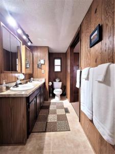 a bathroom with a toilet and a sink at Account to be deleted in Sneads Ferry