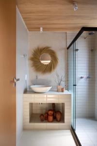a bathroom with a sink and a mirror at Kza Patacho in Pôrto de Pedras