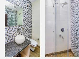 a bathroom with a toilet and a shower at OYO Flagship Ls Banquet & Rooms in New Delhi
