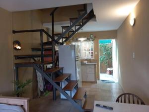 a spiral staircase in a room with a kitchen at Kau Del Valle in General Roca