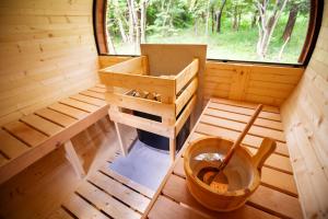 a inside view of a sauna with a large window at LEVATA Nasu バレルサウナ付きログハウス BBQ可 1棟貸切 6名様まで同料金 in Nasu