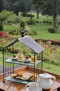 a plate of food on a table with a bird on top at Handara Golf & Resort Bali in Bedugul