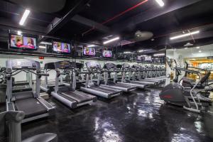a gym with rows of tread machines and televisions at Camino Real Aeropuerto in Mexico City +107 photos