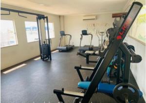 a gym with several tread machines in a room at 1104 - Residence Service in Porto Velho