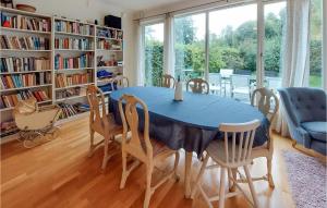 a dining room with a blue table and chairs at Amazing Home In Halmstad With Wifi in Halmstad