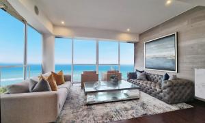 a living room with a couch and a table at OceanFront Larcomar Apartments in Lima
