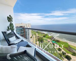 a balcony with a view of the ocean at OceanFront Larcomar Apartments in Lima