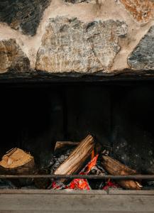 a fire in a stone oven with wood and flames at The Oak & Anchor Hotel in Port Fairy