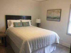 a bedroom with a large bed with a white comforter at Relax with the Whole Family, 6 minutes to Base in Jacksonville
