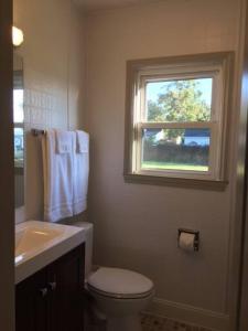 a bathroom with a sink and a toilet and a window at Relax with the Whole Family, 6 minutes to Base in Jacksonville