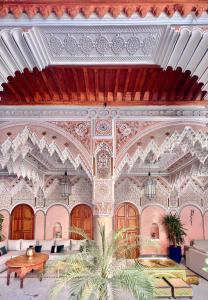 an ornate room with a bed and a table at Riad Azad & Spa in Marrakech