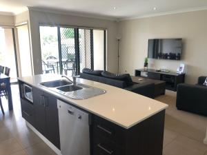 a kitchen and living room with a sink and a couch at Cypress 39 A in Mulwala