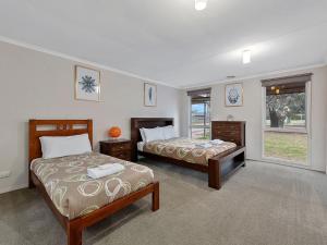 a bedroom with two beds and a window at Lakeside Mulwala in Mulwala