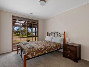 a bedroom with a bed and a window at Lakeside Mulwala in Mulwala