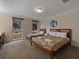 a bedroom with two beds and a window at Lakeside Mulwala in Mulwala +5 photos