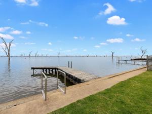 a dock in the middle of a body of water at Lakeside Mulwala in Mulwala