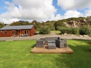 a house with a table and chairs in a yard at Tressa, Tor Down Quarry in Bodmin