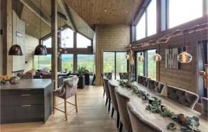 a dining room with a long line of chairs at Amazing Home In Norheimsund With Wifi in Norheimsund