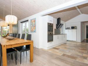a kitchen and dining room with a wooden table and chairs at 16 person holiday home in Ansager-By Traum in Ansager