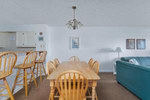 a dining room and kitchen with a table and chairs at 7053 - Hatteras High 5C by Resort Realty in Rodanthe
